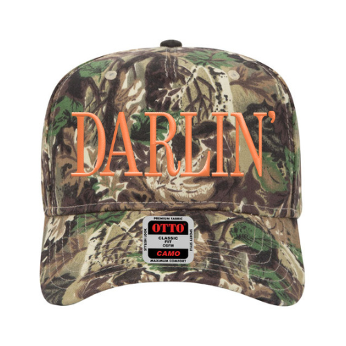 Custom embroidered camo hat with bold ‘Darlin’’ lettering in Safety Orange thread, mid-profile Otto cap style on a neutral background
