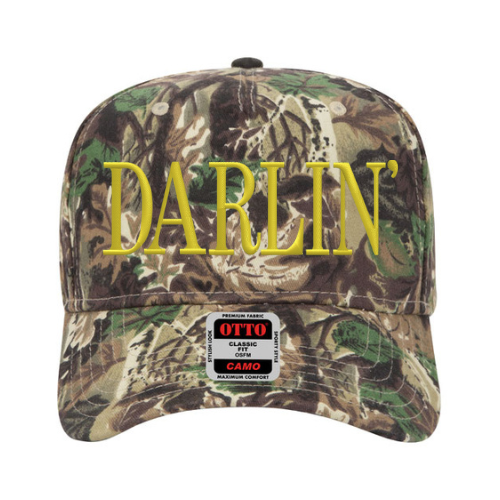 Custom embroidered camo hat with bold ‘Darlin’’ lettering in Old Gold thread, mid-profile Otto cap style on a white background