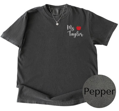 Black t-shirt with 'Ms Taylor' and an apple design on a white background